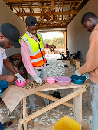 Women farmers doing quality control grading cashew nuts